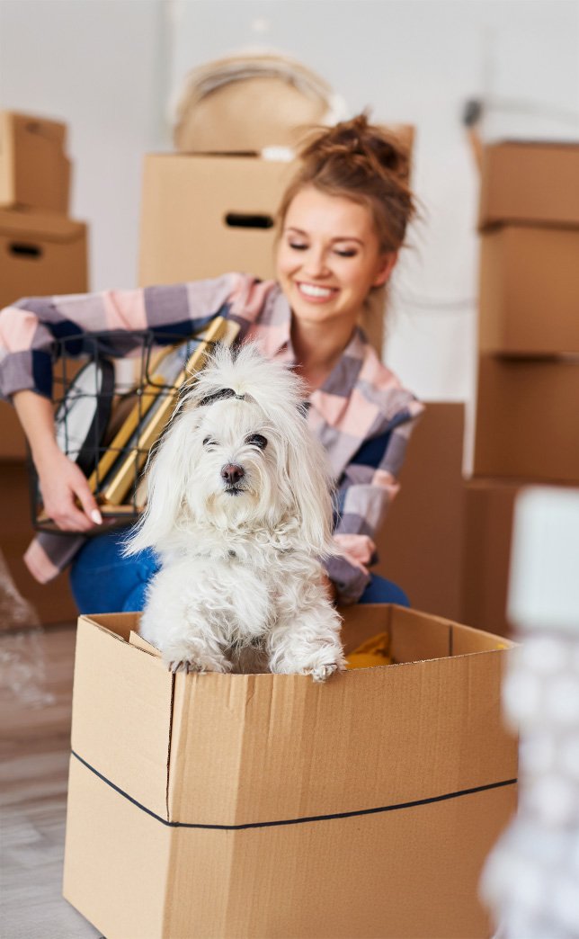 happy-self-storage-customer_mobile smiling self storage customer packing boxes